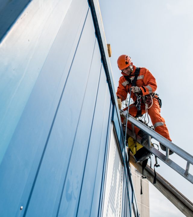 Firefighters in a rescue operation - accident on the roof; all logos removed. Slovenia, Europe. Nikon.
